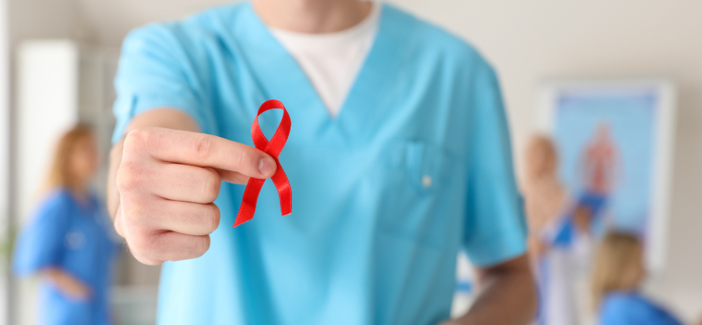 Médico segurando laço vermelho da luta contra a AIDS, simbolizando o suporte clínico necessário para tratamentos com Lenacapavir.